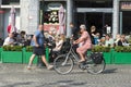 An elderly woman riding her bicycle