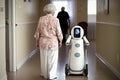 Elderly woman with a robot in the hallway of a hospital