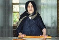 Elderly woman rolling out dough Royalty Free Stock Photo