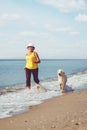 Elderly woman running with her golder retriever Royalty Free Stock Photo