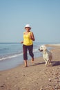 Elderly woman running with her golder retriever Royalty Free Stock Photo