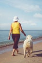 Elderly woman running with her golder retriever Royalty Free Stock Photo