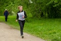 Elderly woman runs on the track at running competition among senior athleties