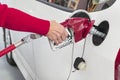 Elderly WomanÃ¢â¬â¢s Hand Pumping Gasoline