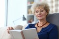 Elderly woman self-isolation reading book at home Royalty Free Stock Photo