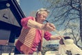 Elderly woman serving a lunch outdoor.