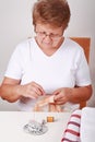 Elderly woman sewing Royalty Free Stock Photo