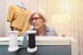 elderly woman sewing behind a sewing machine Royalty Free Stock Photo