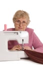 The elderly woman sews on the sewing machine Royalty Free Stock Photo