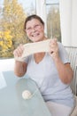 Elderly woman showing her tied a sock.