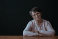 Elderly woman sitting alone Royalty Free Stock Photo