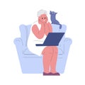 An elderly woman sitting on an armchair with a laptop watches video communicates studies. Modern pensioners and internet