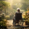 An elderly woman sitting in a wheelchair in the garden, a sick senior woman Royalty Free Stock Photo