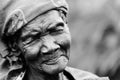 An elderly woman smiles with sadness and modesty in Gulu, Uganda Royalty Free Stock Photo