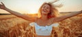 Elderly woman smiling happily in golden sunset wheat field, enjoying the serene moment Royalty Free Stock Photo