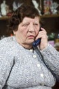 Elderly woman speaking at phone