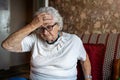 Elderly woman in a state of worry at home Royalty Free Stock Photo