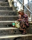 Elderly woman on steps in Myanmar Royalty Free Stock Photo