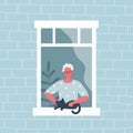 Elderly woman stroking a cat. The old woman at the open window