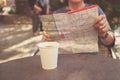 Elderly woman studying map and having coffee Royalty Free Stock Photo