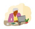 A positively smiling grandmother sits at the computer and studies, communicates with family