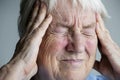 Elderly woman suffering from migraine