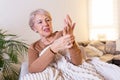 Elderly woman suffering from pain in hand, arthritis old person and senior woman female suffering from pain at home Royalty Free Stock Photo