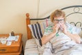 An elderly woman suffers from the flu and runny nose. The pensioner blows her nose in the nasal raft.