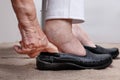 Elderly woman swollen feet putting on shoes Royalty Free Stock Photo