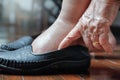 Elderly woman swollen feet putting on shoes Royalty Free Stock Photo