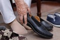 Elderly woman swollen feet putting on shoes