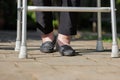 Elderly woman swollen feet using walker