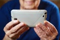 Elderly woman with tablet computer