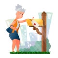 an elderly woman taking a letter out of a mailbox Royalty Free Stock Photo