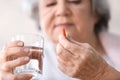 Elderly woman taking pill, closeup Royalty Free Stock Photo