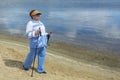 An elderly woman trains in Nordic walking with sticks. Taking care of health and an active lifestyle in old age. Soft focus, blur