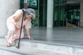 Elderly woman trying to stand up, Using a cane to help Royalty Free Stock Photo