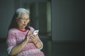 Elderly woman using a phone in a wheelchair Royalty Free Stock Photo