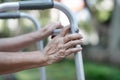 Elderly woman using a walker in backyard Royalty Free Stock Photo