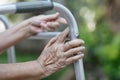 Elderly woman using a walker in backyard Royalty Free Stock Photo