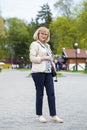 Elderly woman walking in spring park