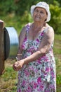 Elderly woman washing hands in washstand outdoor Royalty Free Stock Photo