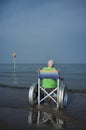 Elderly woman in a wheelchair in the sea