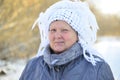 Elderly woman in white knitted shawl on her head Royalty Free Stock Photo