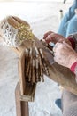 An elderly woman working on hand-made lace or bizzilla Royalty Free Stock Photo
