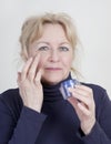 Elderly woman with Wrinkle Cream Royalty Free Stock Photo