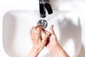 Elderly woman wrinkled hands washing. Hand hygiene to prevent infection. Take care of the elderly.