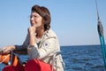 Elderly woman yachtsman on a sailing yacht