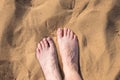 elderly womans feet at the hot sand, top view Royalty Free Stock Photo