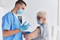 elderly woman arm injection vaccine passport hospital Royalty Free Stock Photo